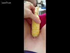 Teen sluggishly drilling herself with a vegetable insertion